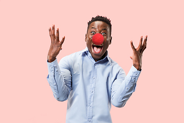 Image showing Portrait of young african-american man looks crazy happy. Red nose day celebrating