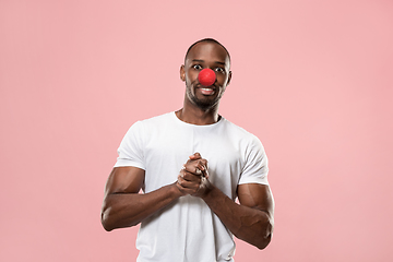 Image showing Portrait of young african-american man smiling. Red nose day celebrating