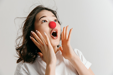 Image showing Portrait of beautiful woman looking suprised. Red nose day celebrating