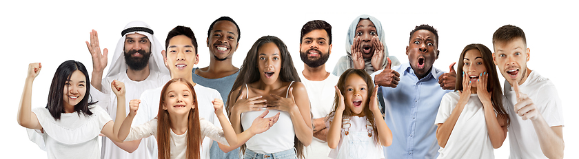 Image showing Portrait of young people looks astonished and happy on white background