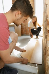 Image showing Young couple doing apartment repair together themselves