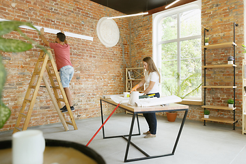 Image showing Young couple doing apartment repair together themselves