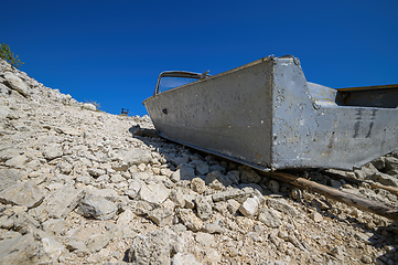 Image showing Empty old metal fishing motor boat at shore