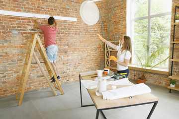 Image showing Young couple doing apartment repair together themselves