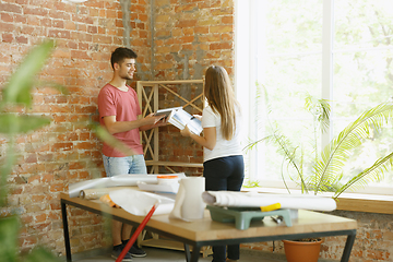 Image showing Young couple doing apartment repair together themselves