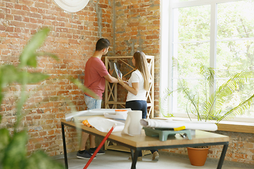 Image showing Young couple doing apartment repair together themselves