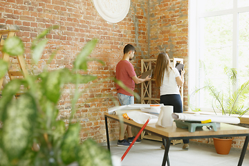 Image showing Young couple doing apartment repair together themselves