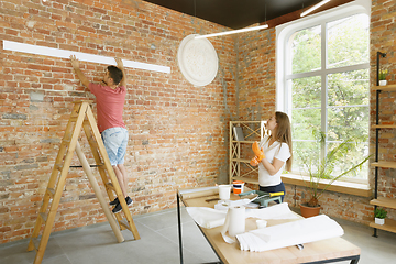 Image showing Young couple doing apartment repair together themselves