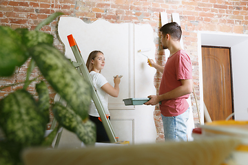 Image showing Young couple doing apartment repair together themselves