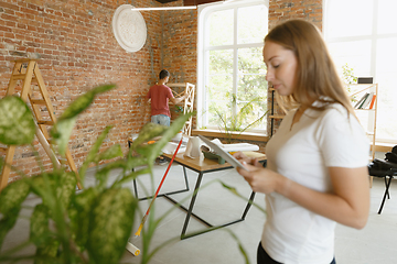 Image showing Young couple doing apartment repair together themselves