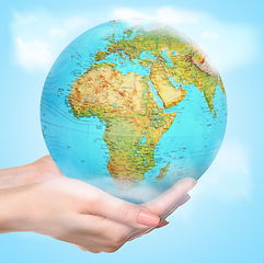 Image showing Save the Earth - female hands caressly holding a globe