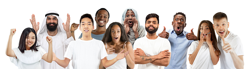 Image showing Portrait of young people looks astonished and happy on white background