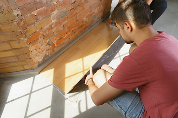 Image showing Young couple doing apartment repair together themselves