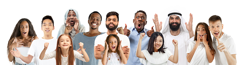 Image showing Portrait of young people looks astonished and happy on white background