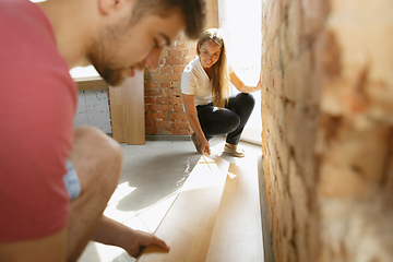 Image showing Young couple doing apartment repair together themselves