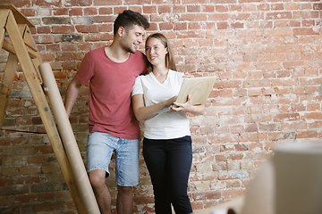 Image showing Young couple doing apartment repair together themselves