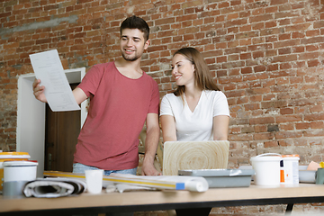 Image showing Young couple doing apartment repair together themselves