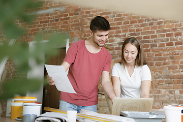 Image showing Young couple doing apartment repair together themselves