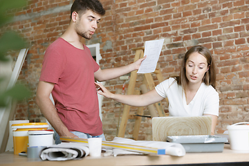 Image showing Young couple doing apartment repair together themselves