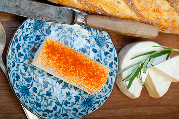 Image showing French cheese and fresh  baguette on a wood cutter