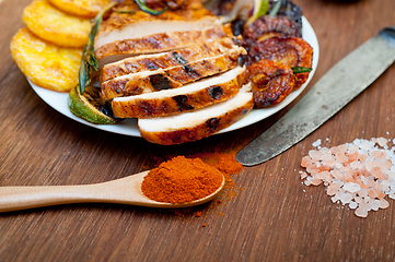 Image showing roasted grilled BBQ chicken breast with herbs and spices 