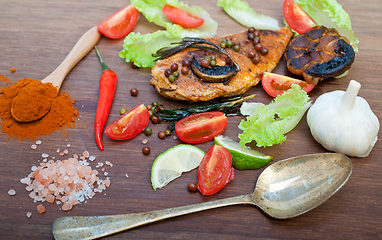 Image showing wood fired hoven cooked chicken breast on wood board 