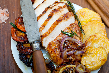 Image showing roasted grilled BBQ chicken breast with herbs and spices 