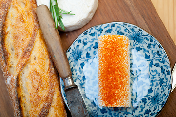 Image showing French cheese and fresh  baguette on a wood cutter