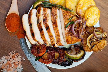 Image showing roasted grilled BBQ chicken breast with herbs and spices 