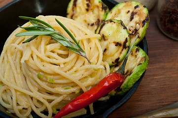 Image showing italian spaghetti pasta with zucchini sauce on iron skillet