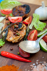 Image showing wood fired hoven cooked chicken breast on wood board 