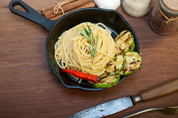 Image showing italian spaghetti pasta with zucchini sauce on iron skillet