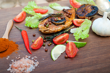 Image showing wood fired hoven cooked chicken breast on wood board 