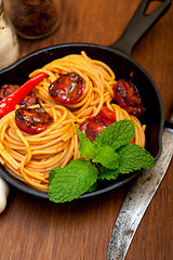 Image showing italian spaghetti pasta and tomato with mint leaves 