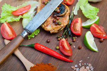 Image showing wood fired hoven cooked chicken breast on wood board 