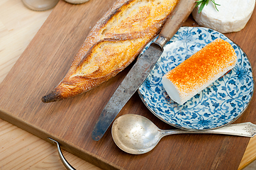 Image showing French cheese and fresh  baguette on a wood cutter