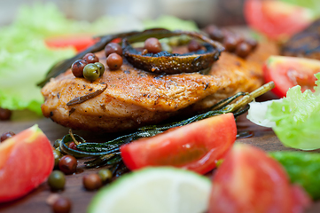 Image showing wood fired hoven cooked chicken breast on wood board 