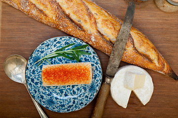 Image showing French cheese and fresh  baguette on a wood cutter