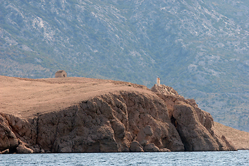 Image showing A hilltop house and lighthouse above the Adriatic sea near the town of Pag.