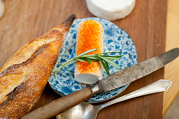 Image showing French cheese and fresh  baguette on a wood cutter