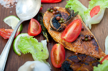 Image showing wood fired hoven cooked chicken breast on wood board 