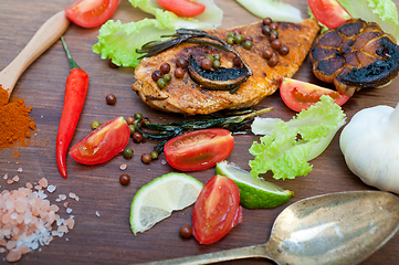 Image showing wood fired hoven cooked chicken breast on wood board 