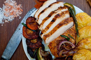 Image showing roasted grilled BBQ chicken breast with herbs and spices 