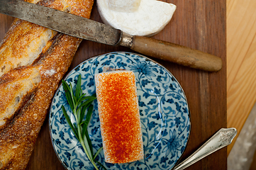 Image showing French cheese and fresh  baguette on a wood cutter