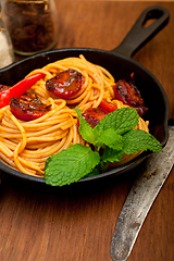 Image showing italian spaghetti pasta and tomato with mint leaves 