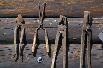 Image showing Old rust tools on wooden background.