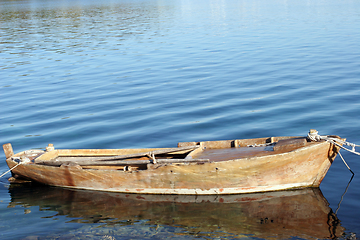 Image showing A wooden rowing boat tide down