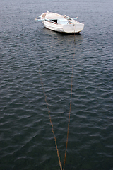 Image showing A wooden rowing boat tide down