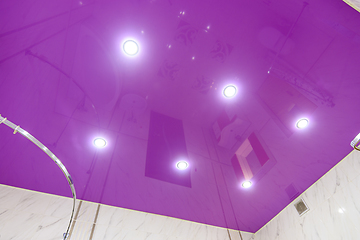 Image showing Stretch glossy ceiling of bright purple color in the bathroom