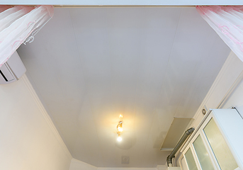 Image showing A budget ceiling made of white plastic panels in a spacious kitchen